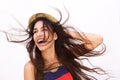 Smiling young woman with long hair blowing in the wind Royalty Free Stock Photo