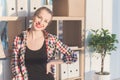 Smiling young woman looking at camera, standing, leaning head, putting hand on the side. Good-looking female worker is Royalty Free Stock Photo