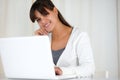 Smiling young woman looking at you using laptop Royalty Free Stock Photo