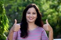Smiling young woman making thumbs up gesture Royalty Free Stock Photo