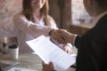 Smiling young woman and man handshake. Agreement