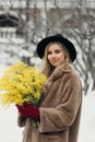 Smiling young woman with mimosa flowers International Women& x27;s Day. Royalty Free Stock Photo