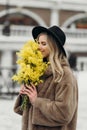 Smiling young woman with mimosa flowers International Women& x27;s Day. Royalty Free Stock Photo