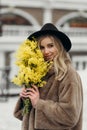 Smiling young woman with mimosa flowers International Women& x27;s Day. Royalty Free Stock Photo