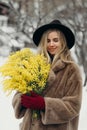 Smiling young woman with mimosa flowers International Women& x27;s Day. Royalty Free Stock Photo