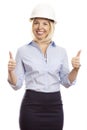 Smiling young woman in office clothes and a construction helmet on her head. Thumbs up. White background Royalty Free Stock Photo