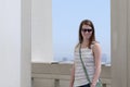 Smiling young woman outdoors with green purse Royalty Free Stock Photo