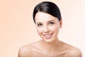 Smiling young woman. Perfect clean skin. Kind face. Closeup beauty