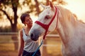 Smiling woman petting a  horse on a ranch on a sunny summer day Royalty Free Stock Photo