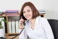 Smiling young woman at phone with customer happy and smile at ofice table Royalty Free Stock Photo