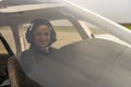 Smiling Young Woman Pilot With Headset Looking Through The Cockpit Window Royalty Free Stock Photo