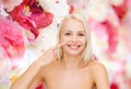 Smiling young woman pointing to her nose Royalty Free Stock Photo