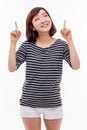 Smiling young woman pointing upwards Royalty Free Stock Photo