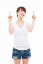 Smiling young woman pointing upwards Royalty Free Stock Photo