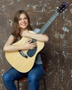 Smiling young woman portrait with acoustic guitar. Royalty Free Stock Photo