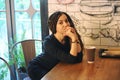 Smiling young woman portrait with dreadlocks and cup of coffee