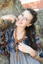 Smiling young woman portrait with dreadlocks hairstyle posing in a sunny outdoor Royalty Free Stock Photo