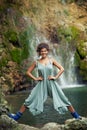 Smiling young woman posing in front of waterfall summer Royalty Free Stock Photo