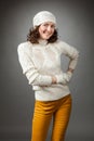Smiling young woman posing in a studio wearing in a sweater and Royalty Free Stock Photo