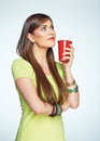 Smiling young woman posing on white background with coffee cup. Royalty Free Stock Photo