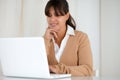 Smiling young woman reading on laptop screen Royalty Free Stock Photo