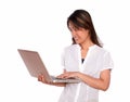 Smiling young woman reading on laptop screen Royalty Free Stock Photo