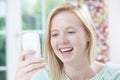 Smiling Young Woman Reading Text Message Royalty Free Stock Photo