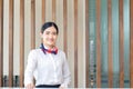 Smiling young woman receptionist standing at workplace and looking to camera. Portrait of Female receptionist working in hotel Royalty Free Stock Photo