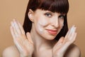 Smiling young woman with red hair washing face by natural foamy gel. Royalty Free Stock Photo