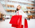 Smiling young woman with red shopping bags Royalty Free Stock Photo