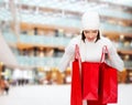 Smiling young woman with red shopping bags Royalty Free Stock Photo