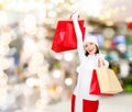 Smiling young woman with red shopping bags Royalty Free Stock Photo