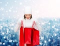 Smiling young woman with red shopping bags Royalty Free Stock Photo