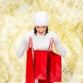 Smiling young woman with red shopping bags Royalty Free Stock Photo