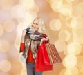 Smiling young woman with red shopping bags Royalty Free Stock Photo