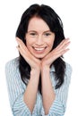 Smiling young woman resting her chin over palms Royalty Free Stock Photo