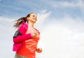 Smiling young woman running outdoors Royalty Free Stock Photo