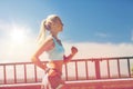 Smiling young woman running outdoors Royalty Free Stock Photo