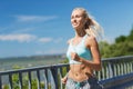 Smiling young woman running outdoors Royalty Free Stock Photo