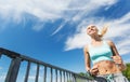 Smiling young woman running outdoors Royalty Free Stock Photo