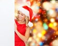 Smiling young woman in santa hat with white board Royalty Free Stock Photo
