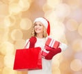 Smiling young woman in santa helper hat with gifts Royalty Free Stock Photo