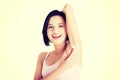 Smiling young woman shaving her armpit Royalty Free Stock Photo