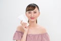 Smiling young woman showing skincare products Royalty Free Stock Photo