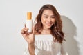 Smiling young woman showing skincare products Royalty Free Stock Photo