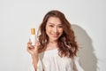 Smiling young woman showing skincare products. Royalty Free Stock Photo