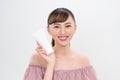 Smiling young woman showing skincare products Royalty Free Stock Photo