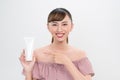 Smiling young woman showing skincare products Royalty Free Stock Photo