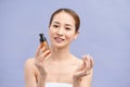 Smiling young woman showing skincare products Royalty Free Stock Photo