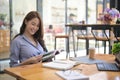 Smiling woman sitting in cafe and reading a book. Royalty Free Stock Photo